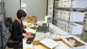 Archivist Kim Hayden works on cataloging the DEC photo library, part of the Digital Equipment Corporation corporate records processed under CHM APP.