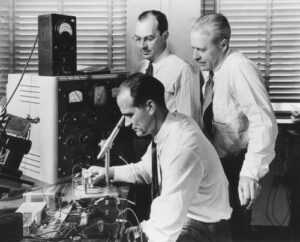William Shockley (seated) with his Bell Labs colleagues John Bardeen (standing left) and Walter Brattain (standing right) in 1948. The trio later shared the Nobel Prize in physics for their pioneering work on the transistor. Credit: Bell Laboratories